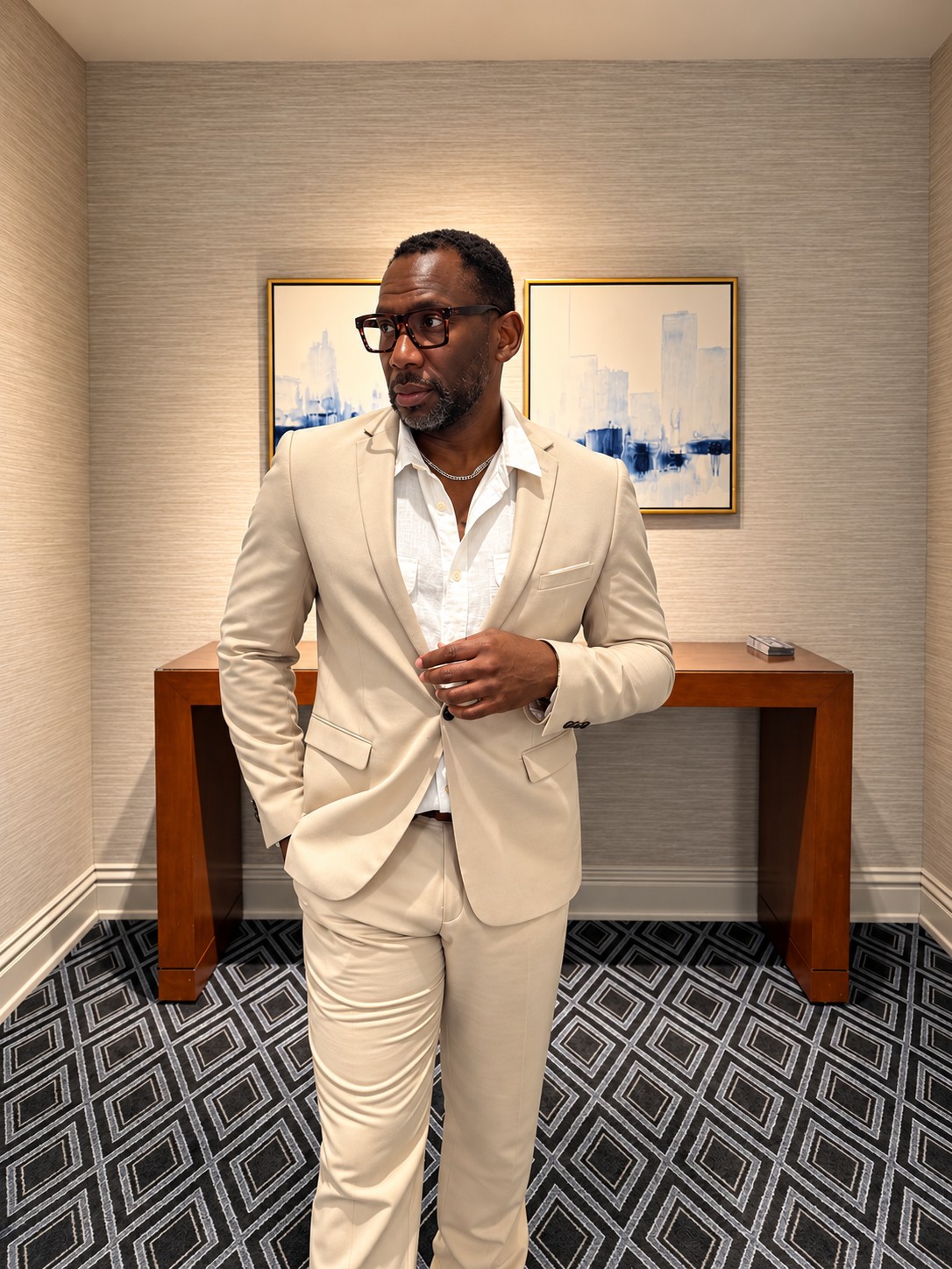 Christopher Burnam wearing a cream suit