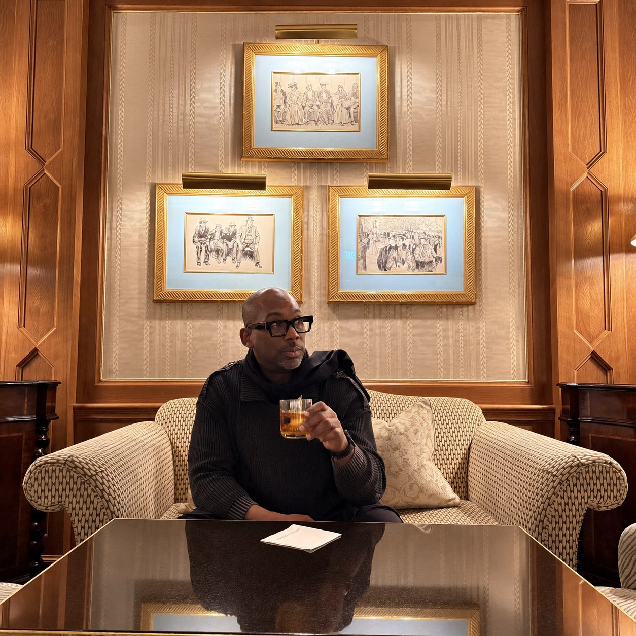 Christopher Burnam enjoying a drink in an elegant hotel lounge