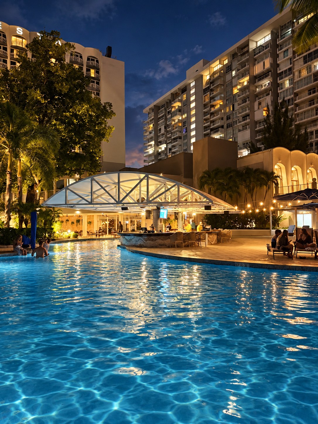 Hotel pool and bar illuminated at night